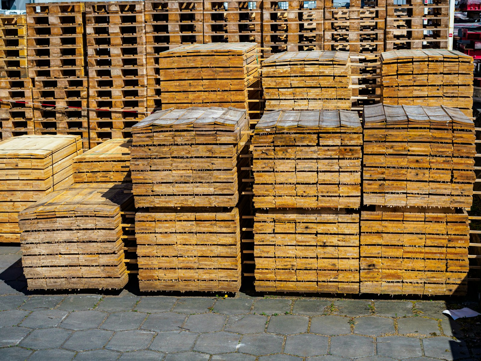 Stacks of wooden pallets in an outdoor storage area